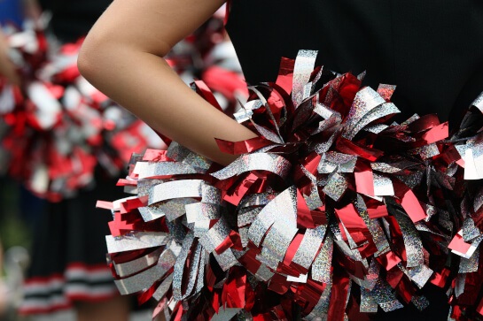 Cheerleader holding pom pom
