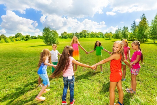 Elementary school girls holding hands in circle