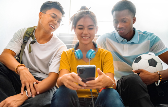 High school students looking at cell phone