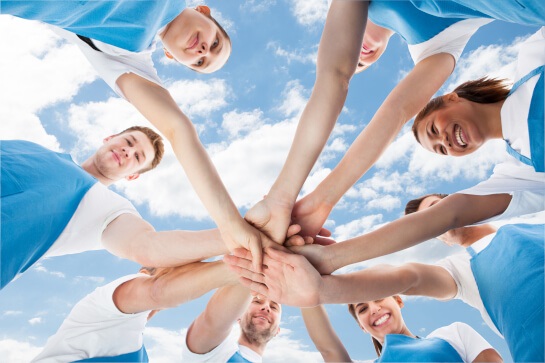 Students putting hands together