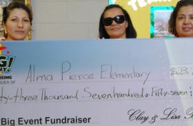 Alma Pierce Elementary School fundraising team holding check