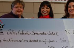 Col. Santos Benavides School fundraising team holding check