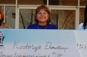 Kostoryz Estates Elementary School fundraising team holding check