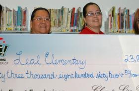 Leal Elementary School fundraising team holding check