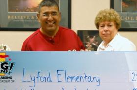 Lyford Elementary School fundraising team holding check