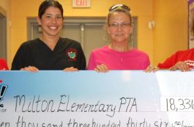 Milton Elementary School PTA fundraising team holding check