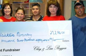 Stricklin Elementary School fundraising team holding check