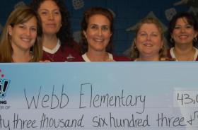 Webb Elementary School fundraising team holding check