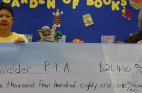 Welder Elementary School PTA fundraising team holding check